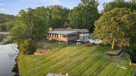 Aerial view of the lawn sloping to the water