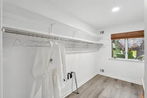The primary walk-in closet with robes