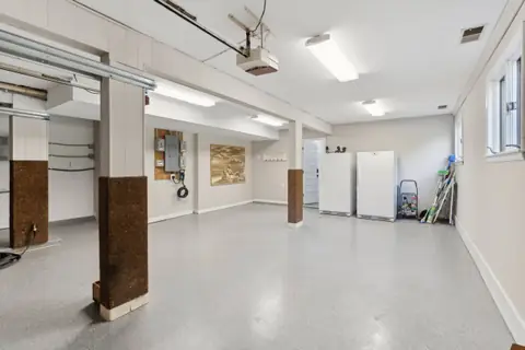 The garage with the EV charger and the elevator entrance