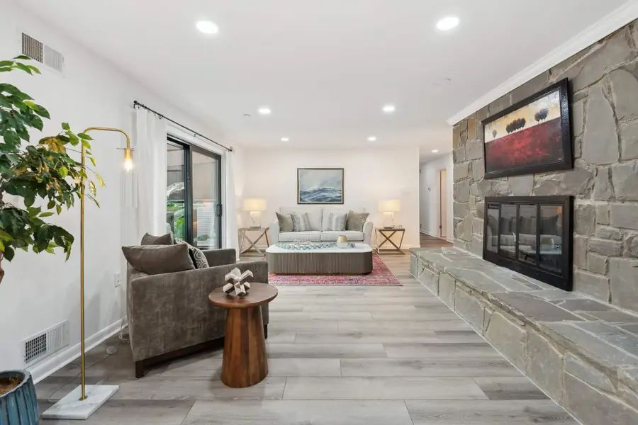 The living room with a stone fireplace