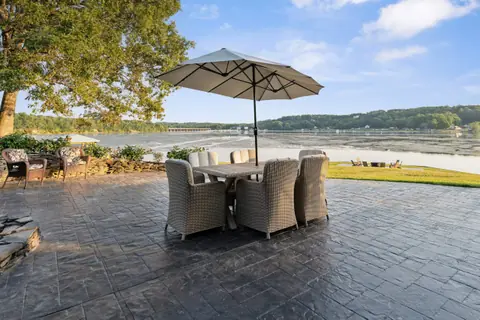 Outdoor dining under an umbrella on the upper patio