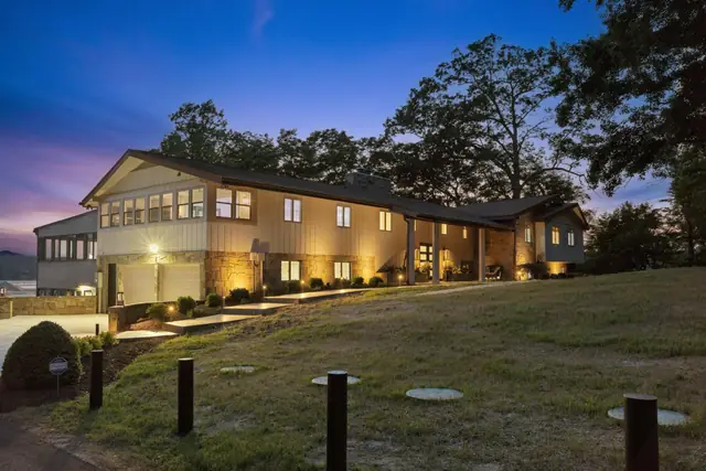 The house at dusk with lights along the path