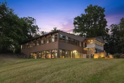 The pool house glowing at twilight